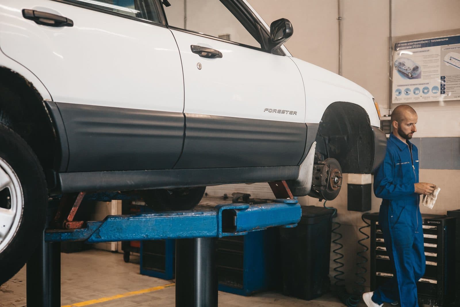 Car raised on a workshop lift for repairs and servicing