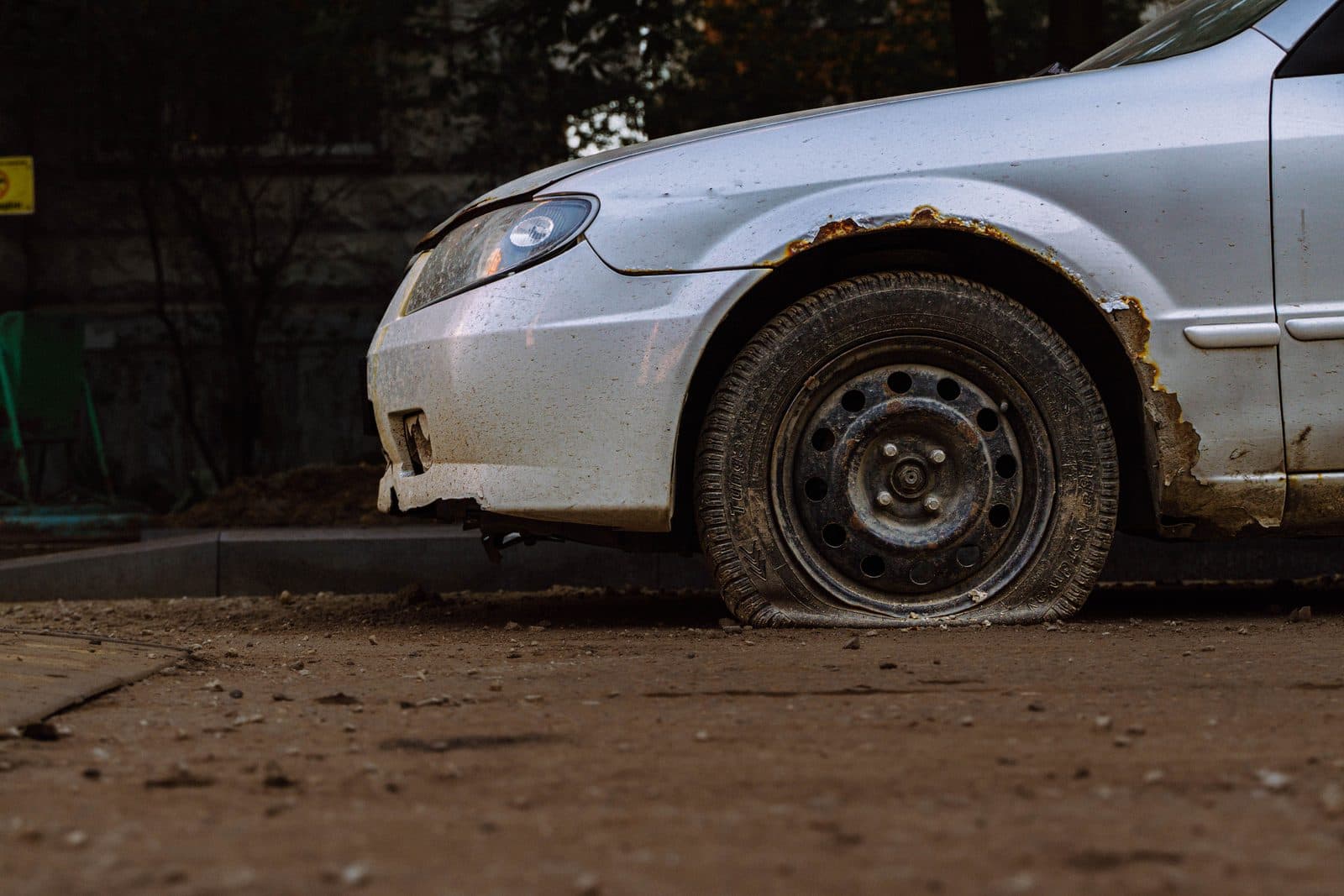 Close-up of a flat tyre on a car needing a roadside change