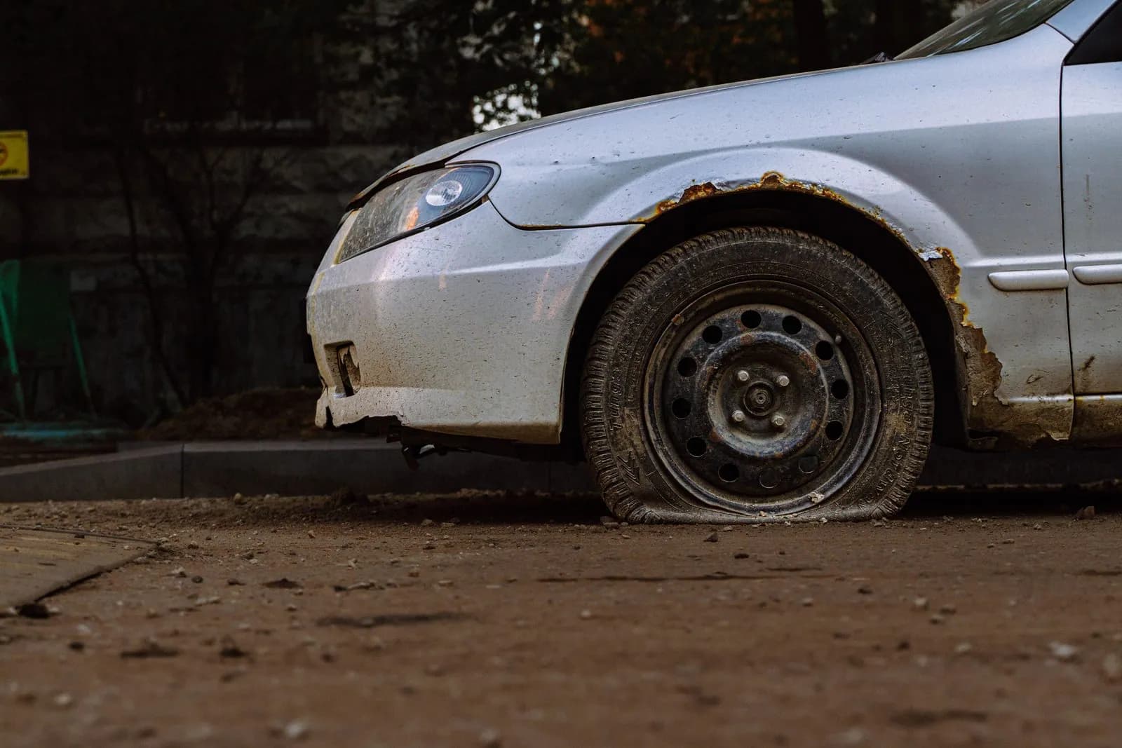 Close-up of a flat tyre on a car needing a roadside change